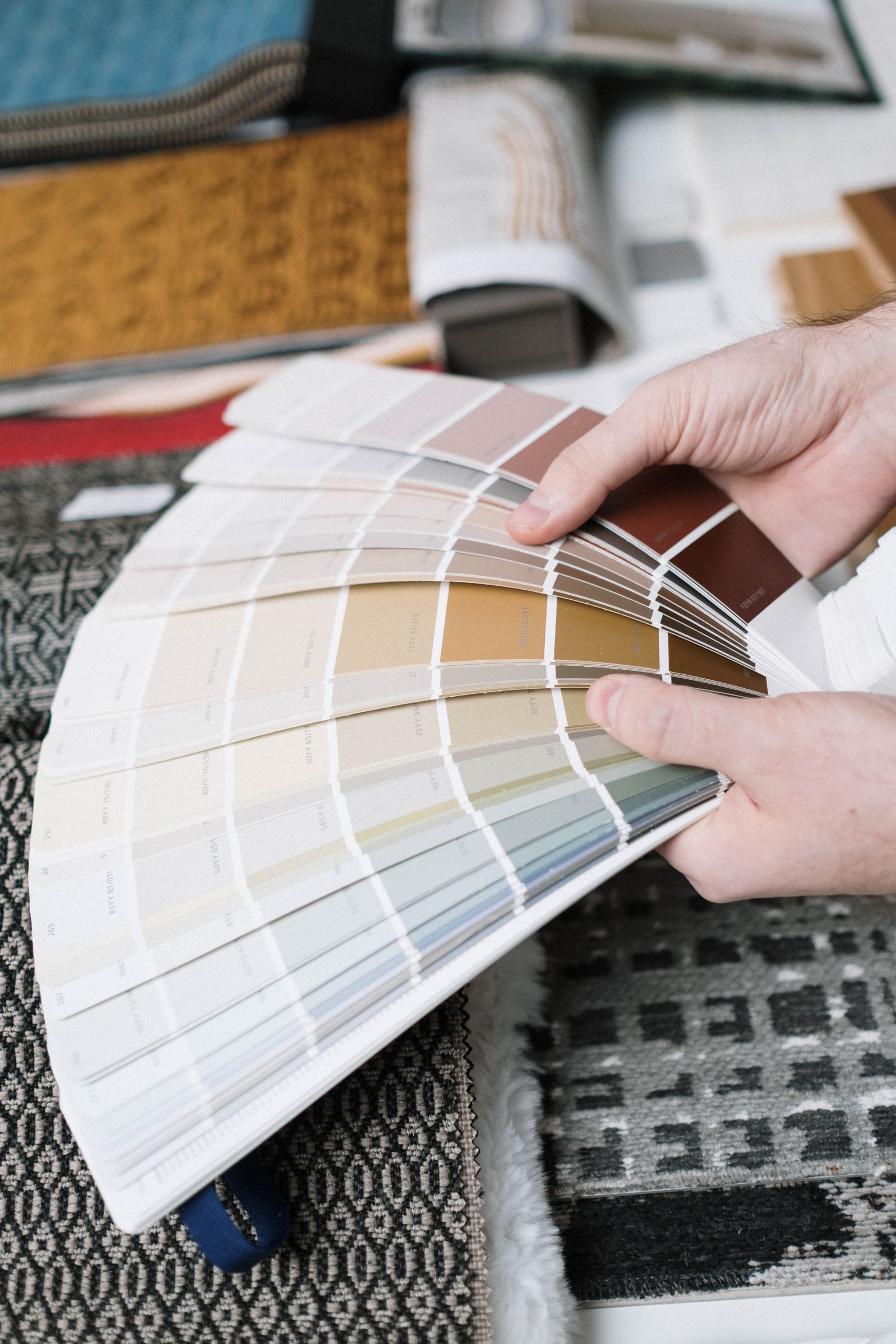 Hand fanning color swatches for the apartment palette