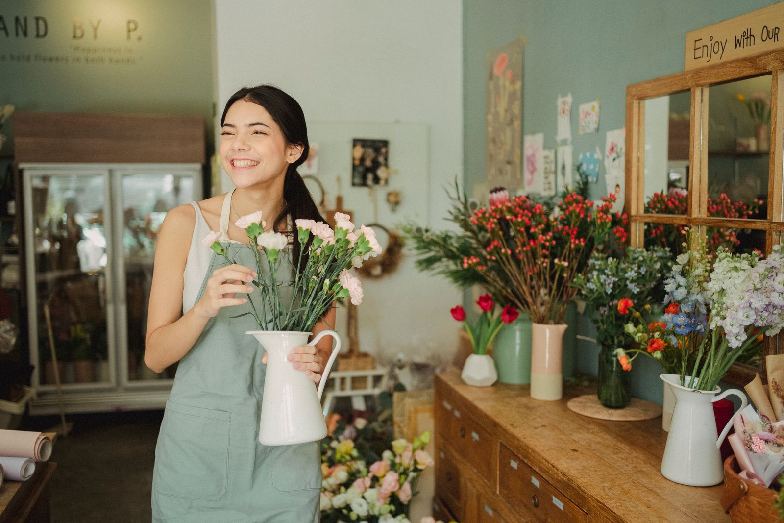 Florist standing with a vase of flowers