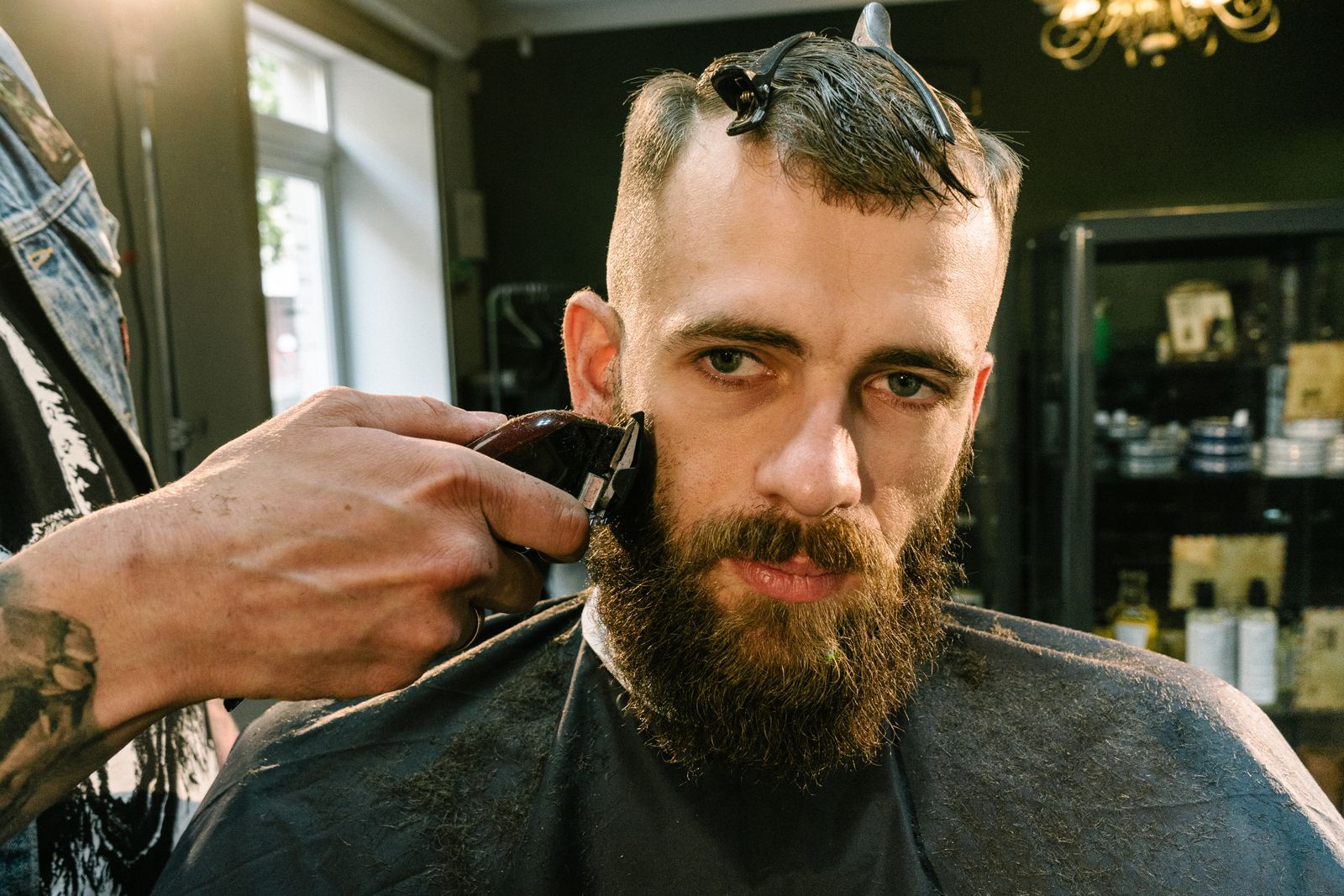 Barber shaving a client's beard